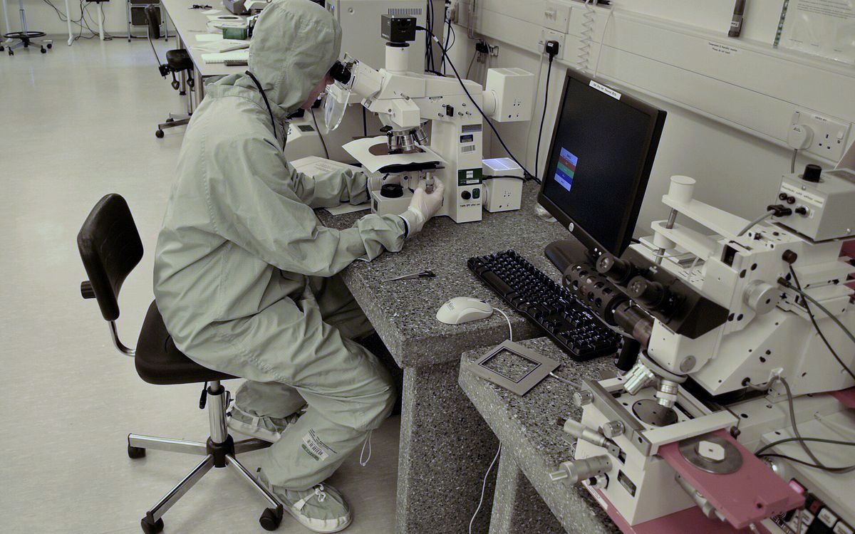 Two researchers working at laboratory workstations